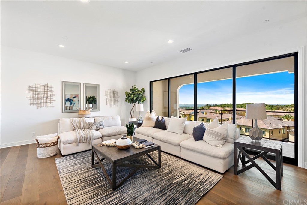 186 Leafy Pass Irvine, CA 92602 - Photo 37 of 59 a living room with furniture city view and large windows