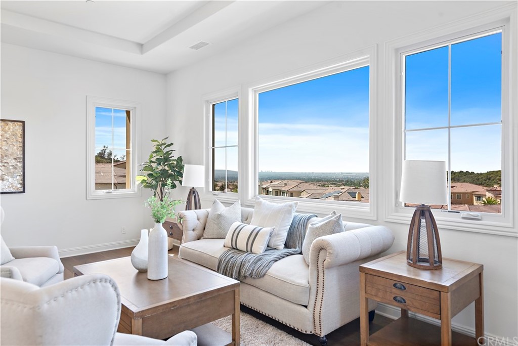 186 Leafy Pass Irvine, CA 92602 - Photo 53 of 59 a living room with furniture kitchen view and large windows