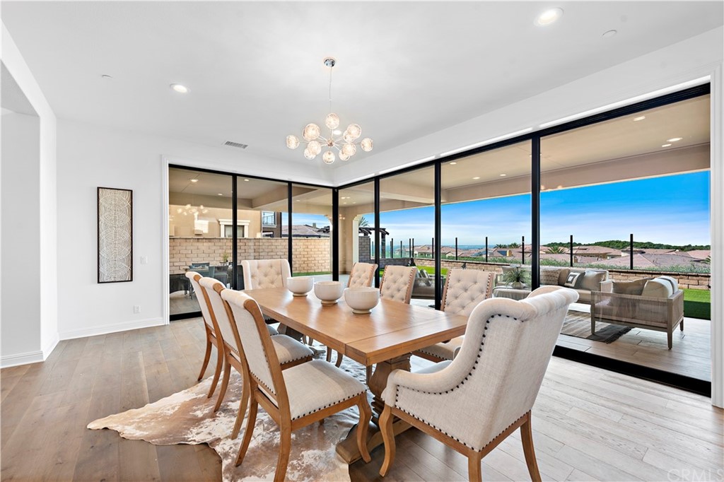 186 Leafy Pass Irvine, CA 92602 - Photo 10 of 59 a dining room with furniture and wooden floor