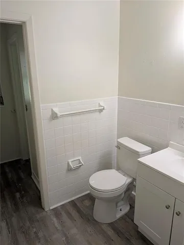 a white toilet sitting next to a shower