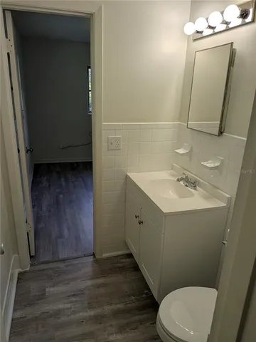 a bathroom with a sink a toilet and mirror