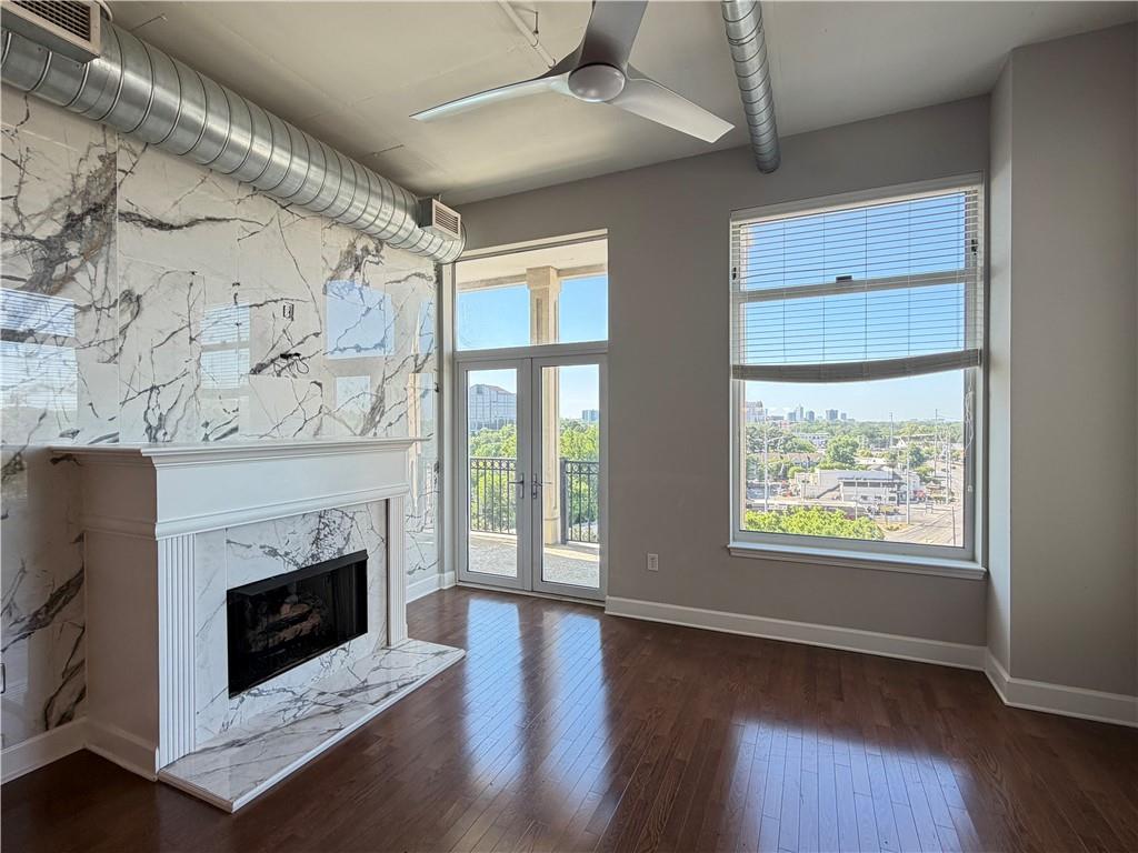 wooden floor fireplace and windows in an empty room