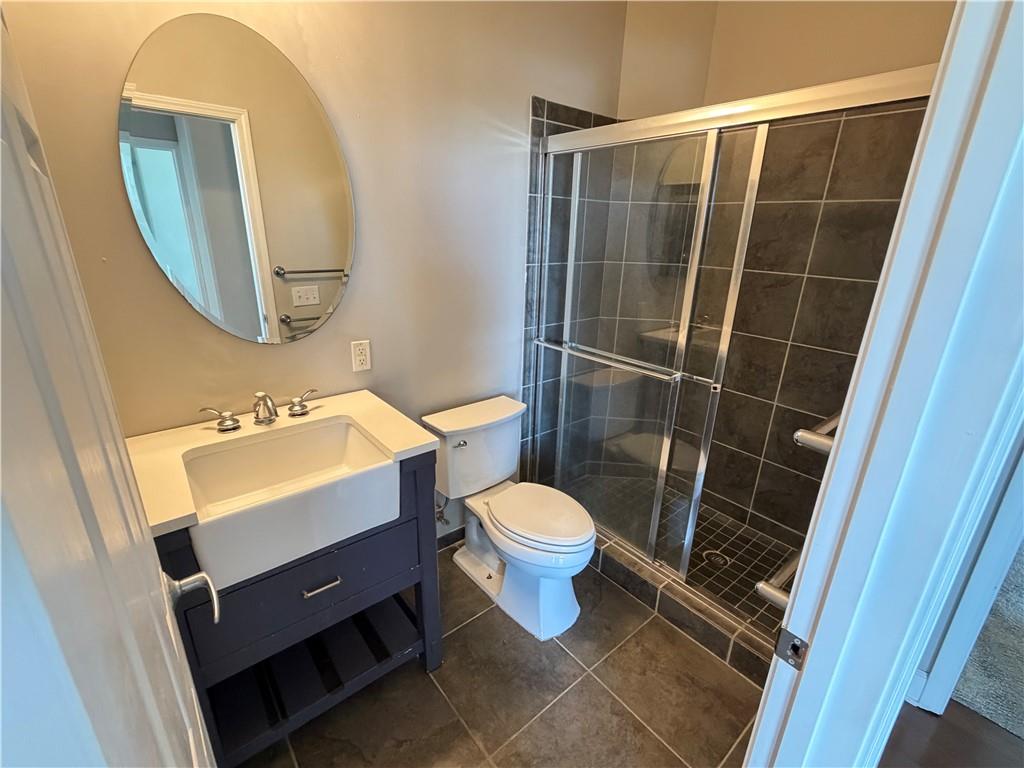 3820 Roswell Road Northeast, Unit 902 Atlanta, GA 30342 - Photo 13 of 20 a bathroom with a sink toilet and shower