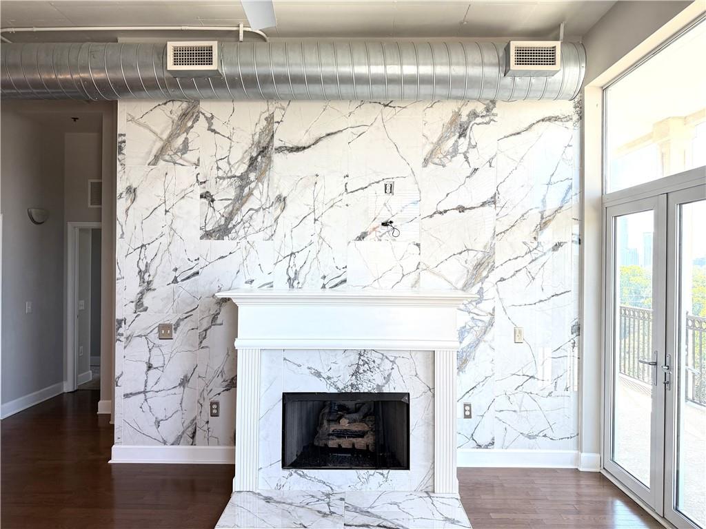 3820 Roswell Road Northeast, Unit 902 Atlanta, GA 30342 - Photo 16 of 20 a living room with a fireplace and a window