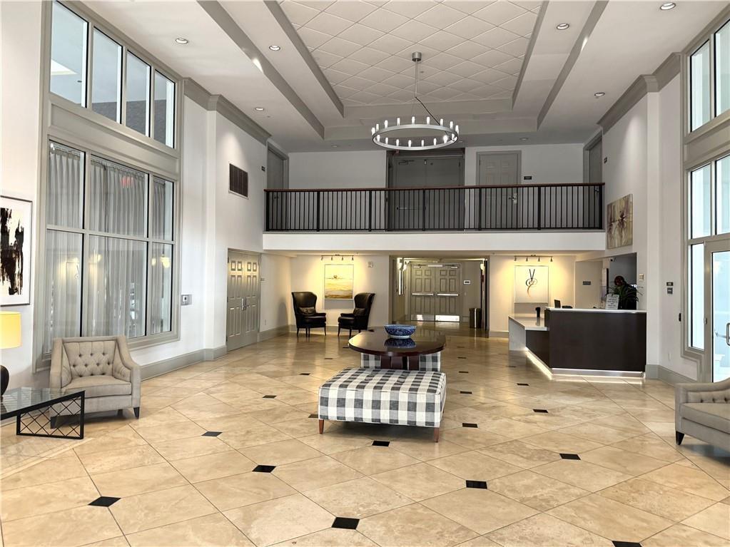 3820 Roswell Road Northeast, Unit 902 Atlanta, GA 30342 - Photo 17 of 20 a living room with furniture chandelier and kitchen view