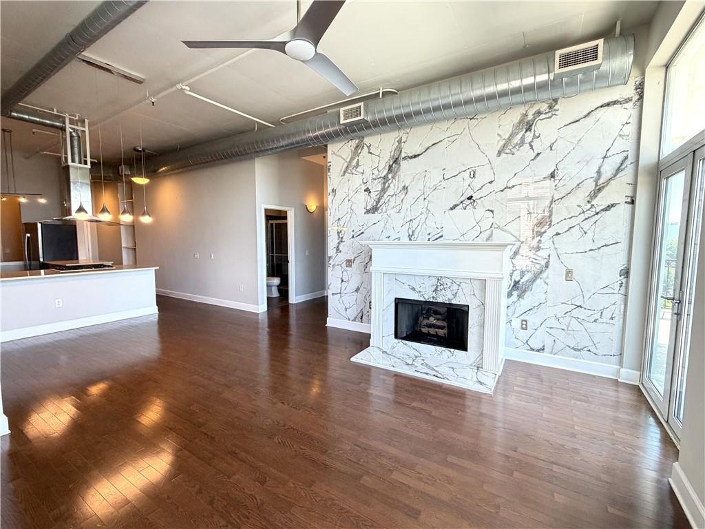 3820 Roswell Road Northeast, Unit 902 Atlanta, GA 30342 - Photo 3 of 20 a view of a big room with wooden floor fireplace and windows