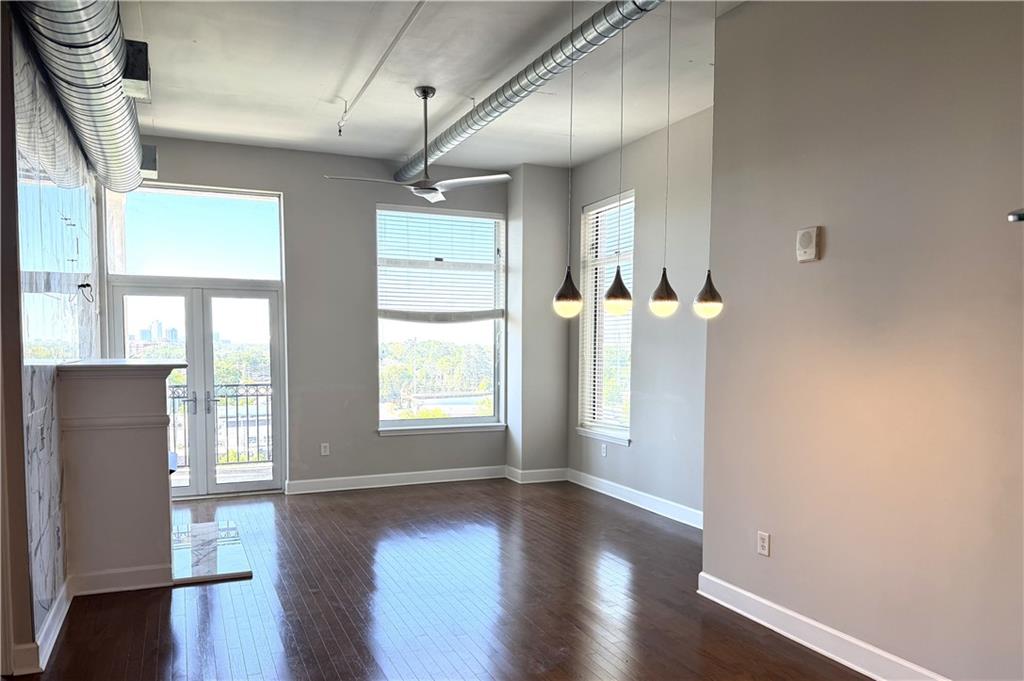 3820 Roswell Road Northeast, Unit 902 Atlanta, GA 30342 - Photo 9 of 20 an empty room with wooden floor and windows