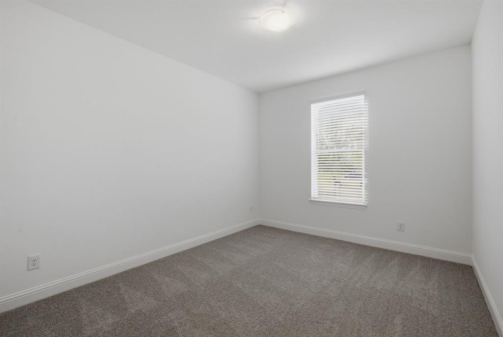 2911 Hanscom Street Forney, TX 75126 - Photo 33 of 40 Neutral-toned carpeting paired with white walls, a single window with blinds, and a flush-mount ceiling light