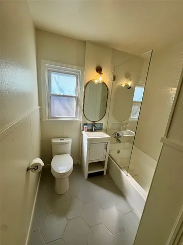 a bathroom with a sink toilet and a mirror