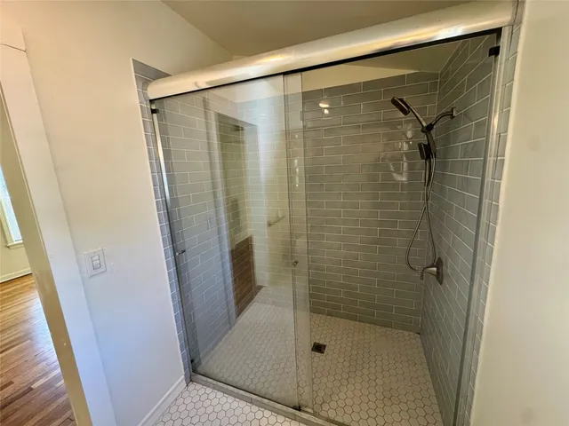 a bathroom with a glass door shower