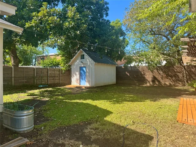 a backyard of a house with table and chairs