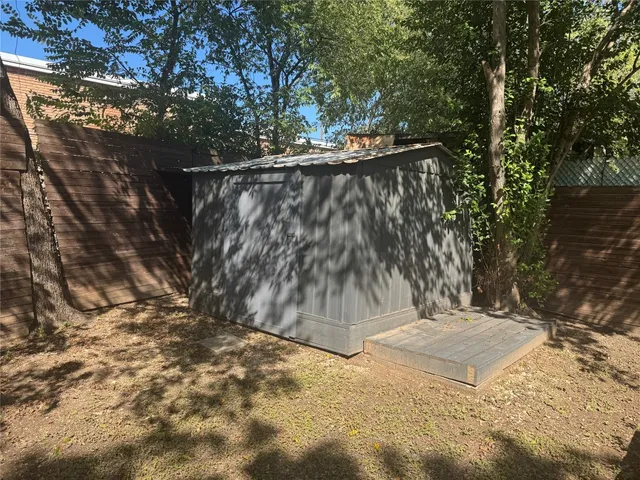 a view of a yard with wooden fence