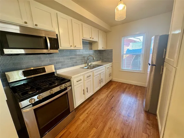 a kitchen with stainless steel appliances a stove a microwave and cabinets