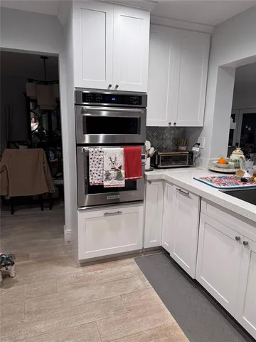 a living room with furniture gym equipment and a wooden floor