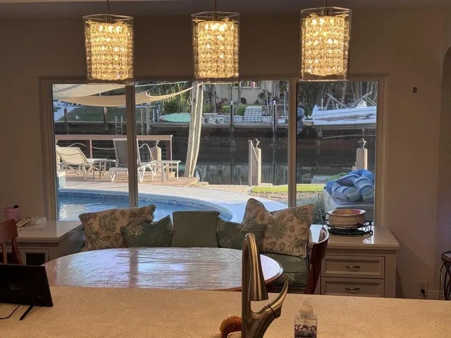 a bedroom with a bed lamp and mirror on the dresser