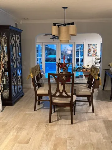 a view of a house with a yard and potted plants
