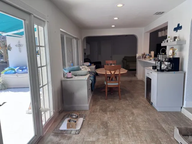 a kitchen with stainless steel appliances a stove a sink cabinets and a window
