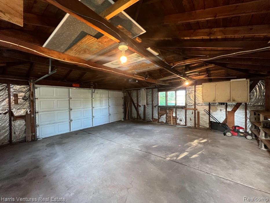 28482 Sutherland Avenue Warren, MI 48088 - Photo 25 of 25 Spacious garage featuring a concrete floor, exposed wood beam ceiling