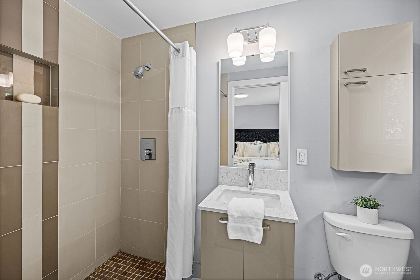 8629 223rd Street Southwest Edmonds, WA 98026 - Photo 19 of 40 a bathroom with a sink toilet a mirror and shower