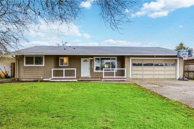 a front view of a house with a garden