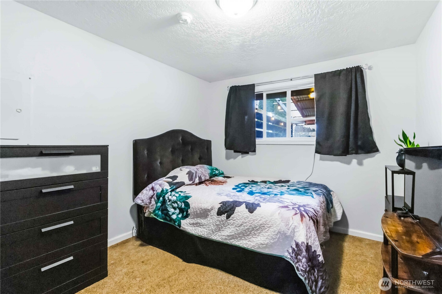 2323 48th Avenue Longview, WA 98632 - Photo 13 of 18 a bedroom with a bed and a lamp on the dresser