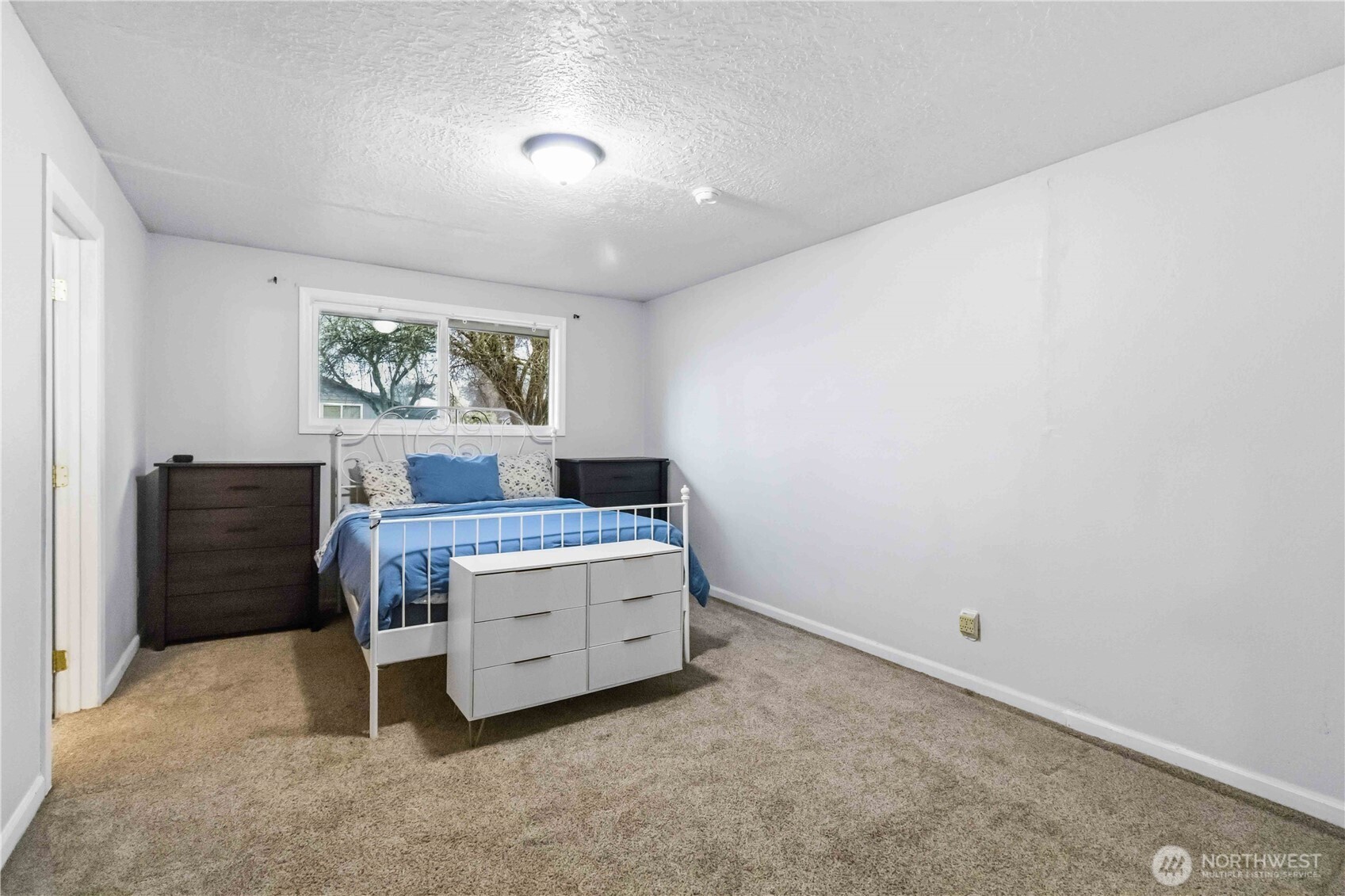 2323 48th Avenue Longview, WA 98632 - Photo 14 of 18 a room with a bed and a painting on the wall
