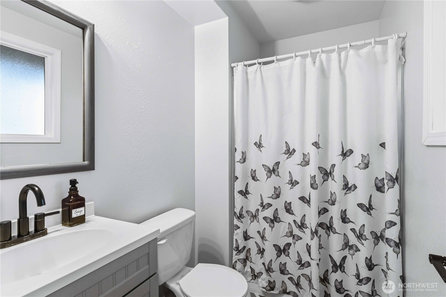 2323 48th Avenue Longview, WA 98632 - Photo 16 of 18 a bathroom with a sink and a mirror