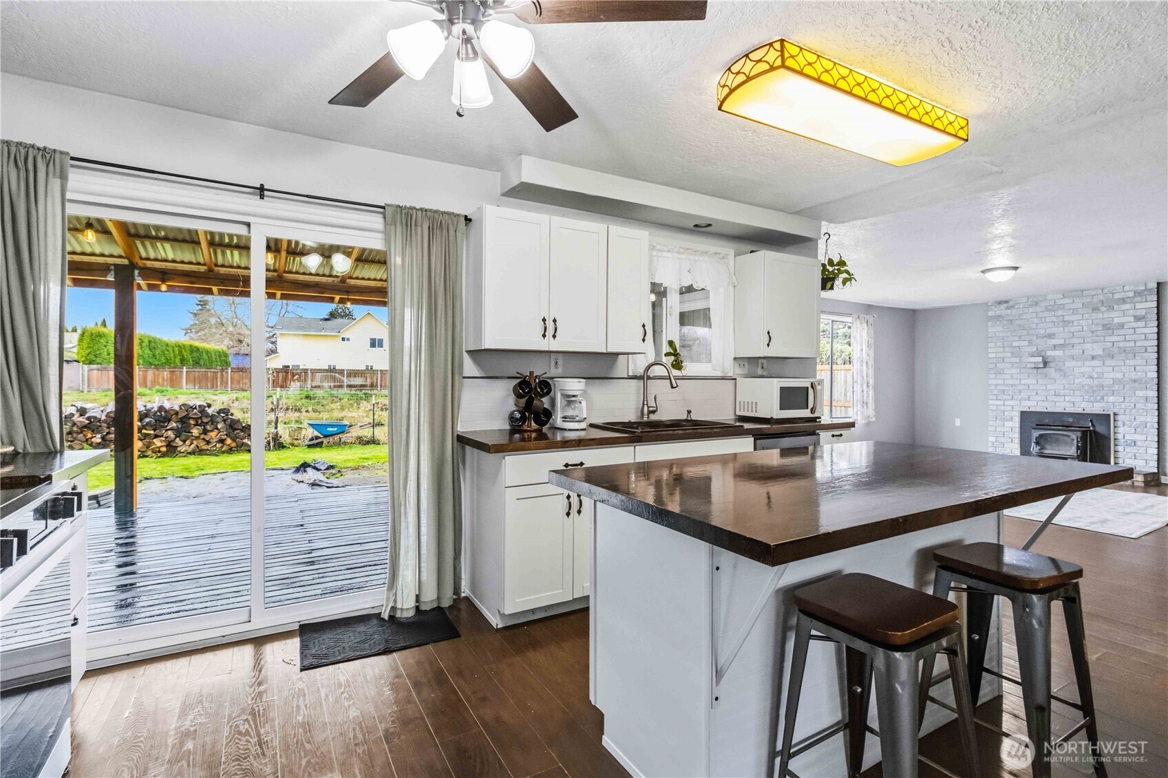 2323 48th Avenue Longview, WA 98632 - Photo 7 of 18 a kitchen with stainless steel appliances granite countertop a stove a refrigerator a sink and a dining table with wooden floor