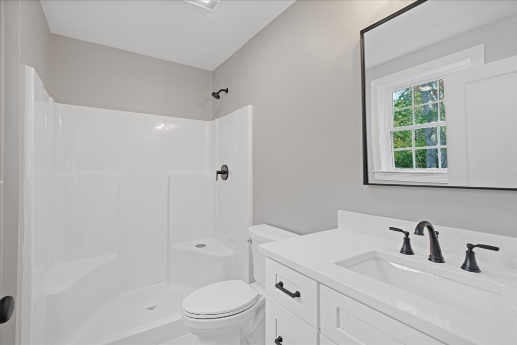509 Mendon Road, Unit 509 Attleboro, MA 02703 - Photo 16 of 31 a bathroom with a sink toilet vanity and shower