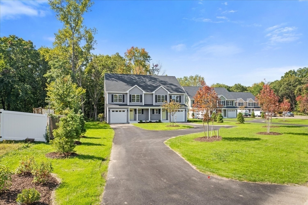 509 Mendon Road, Unit 509 Attleboro, MA 02703 - Photo 3 of 31 a front view of a house with a yard table and chairs