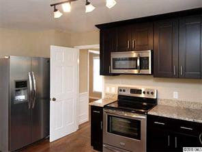 3526 High Ridge Road Charlotte, NC 28270 - Photo 6 of 16 a kitchen with stainless steel appliances granite countertop wooden cabinets stove and microwave