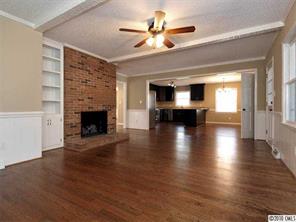 3526 High Ridge Road Charlotte, NC 28270 - Photo 9 of 16 a view of an empty room with wooden floor a fireplace