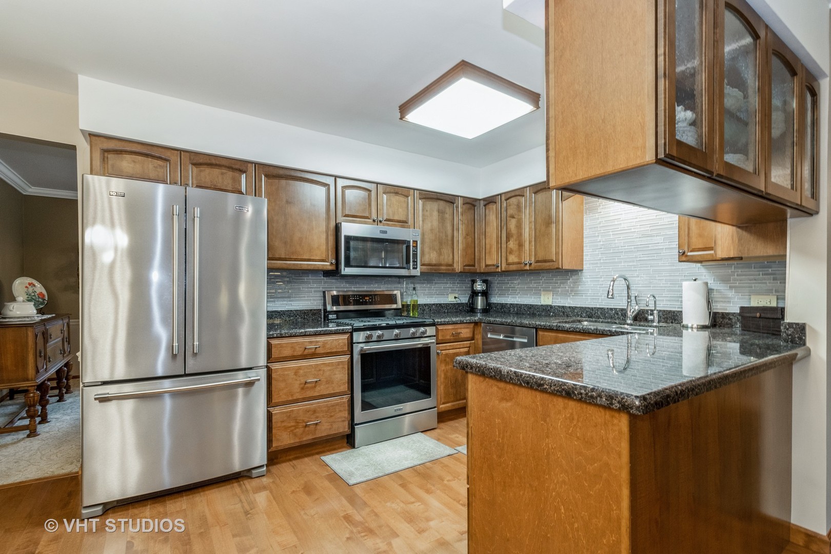 695 Vermont Road Frankfort, IL 60423 - Photo 5 of 20 a kitchen with stainless steel appliances granite countertop a refrigerator a stove a sink a dining table and chairs