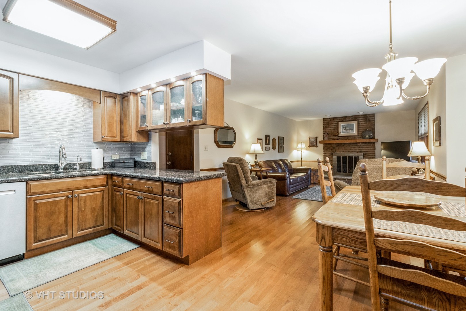 695 Vermont Road Frankfort, IL 60423 - Photo 6 of 20 a living room with stainless steel appliances granite countertop furniture a fireplace a rug and a window