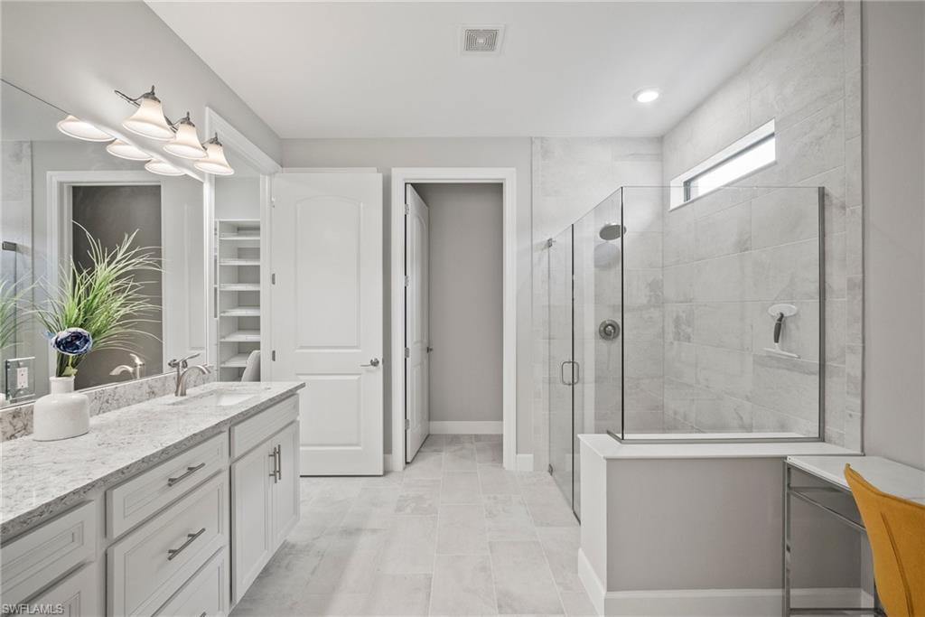 14227 Wild Timber Court Estero, FL 33928 - Photo 15 of 49 a bathroom with a double vanity sink mirror and shower