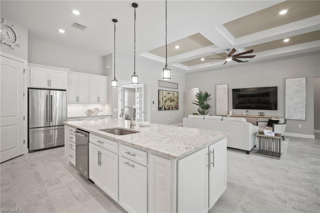 14227 Wild Timber Court Estero, FL 33928 - Photo 31 of 49 a kitchen with a sink center island and stainless steel appliances