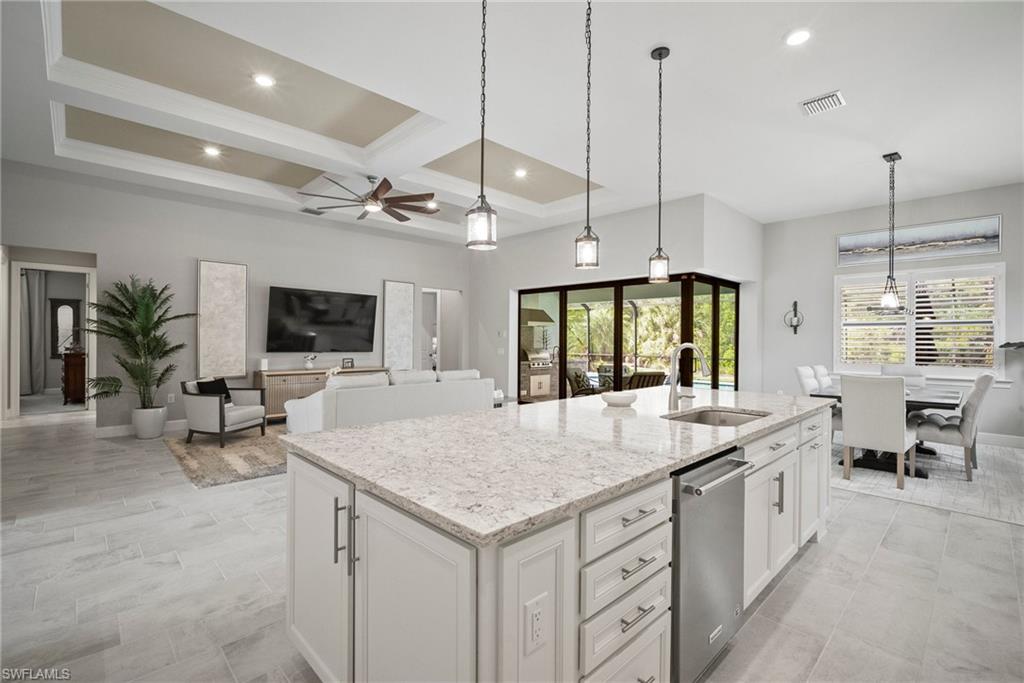 14227 Wild Timber Court Estero, FL 33928 - Photo 32 of 49 a large kitchen with kitchen island a large island in it
