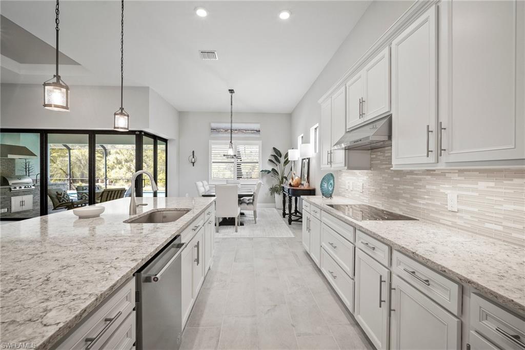 14227 Wild Timber Court Estero, FL 33928 - Photo 33 of 49 a large kitchen with granite countertop lots of counter space and window