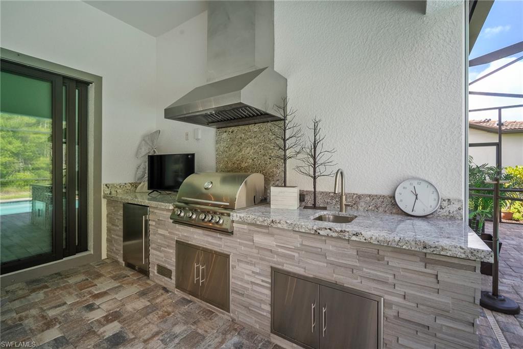 14227 Wild Timber Court Estero, FL 33928 - Photo 37 of 49 a kitchen with stainless steel appliances granite countertop a sink and a stove