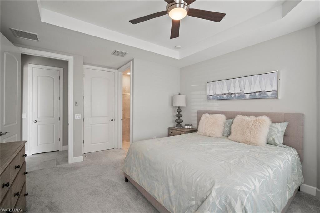 14227 Wild Timber Court Estero, FL 33928 - Photo 6 of 49 a bedroom with a large bed and a chandelier