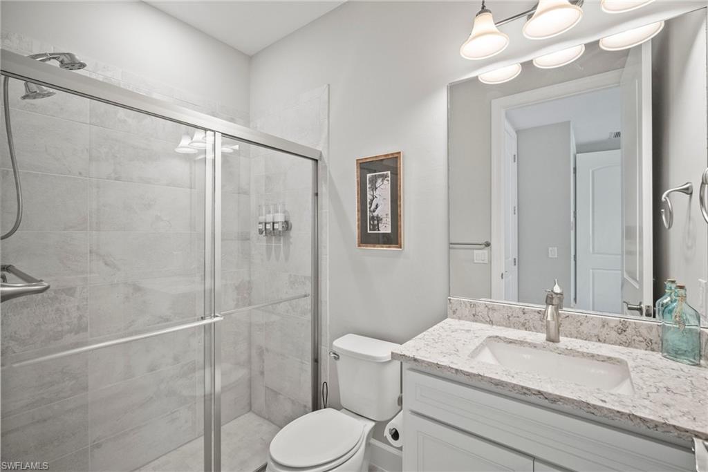 14227 Wild Timber Court Estero, FL 33928 - Photo 7 of 49 a bathroom with a granite countertop sink toilet and shower