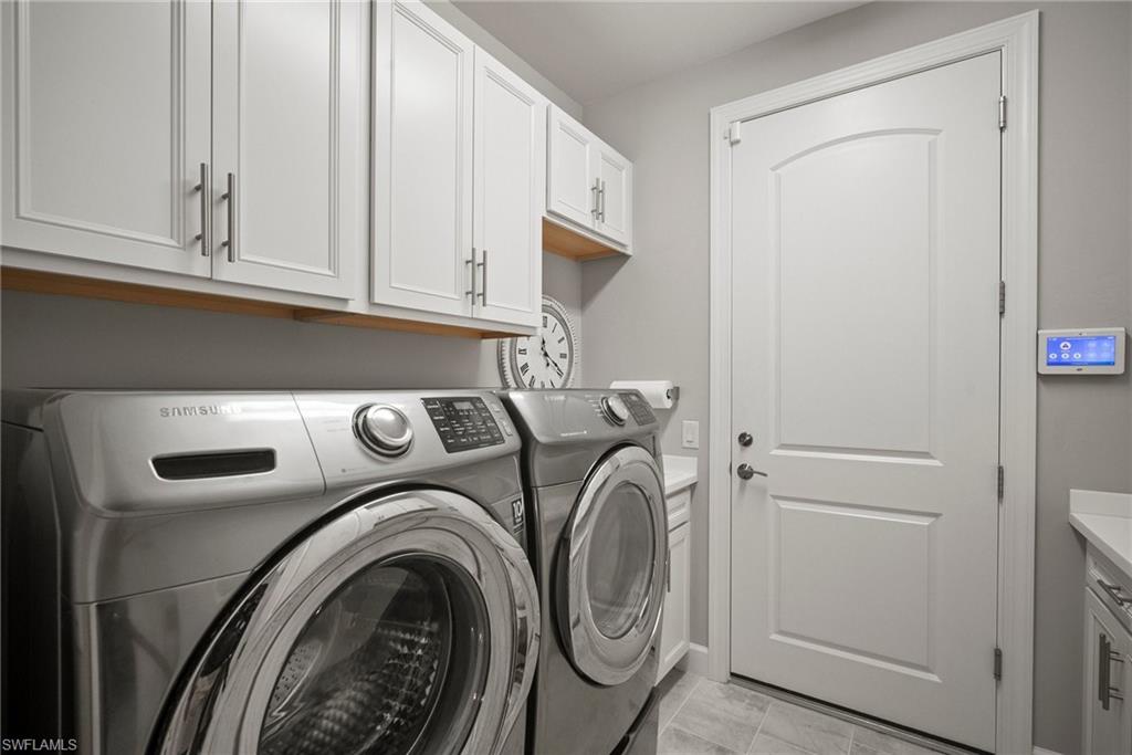 14227 Wild Timber Court Estero, FL 33928 - Photo 9 of 49 a utility room with dryer and washer