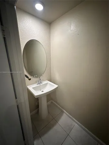 a bathroom with a sink a mirror and a toilet