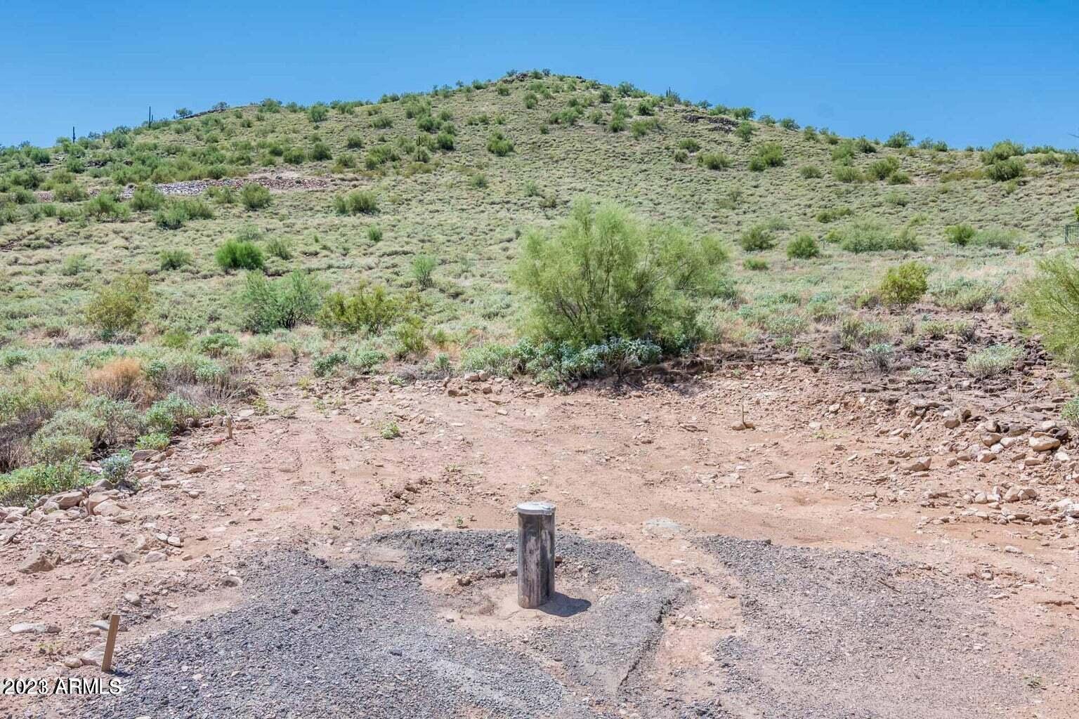 0 West Irvine Road Phoenix, AZ 85086 - Photo 5 of 13 a view of a dry field with trees in the background