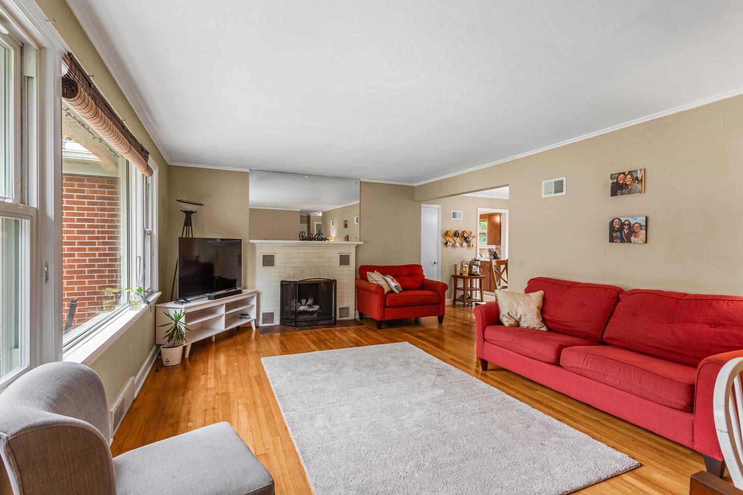 1117 West Union Street Champaign, IL 61821 - Photo 9 of 29 a living room with furniture flat screen tv and windows