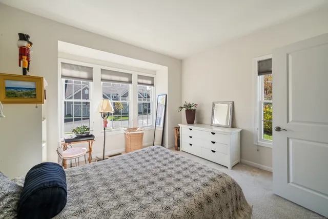 a bedroom with a bed and large window