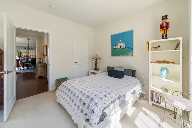 a bedroom with a bed and a view of kitchen