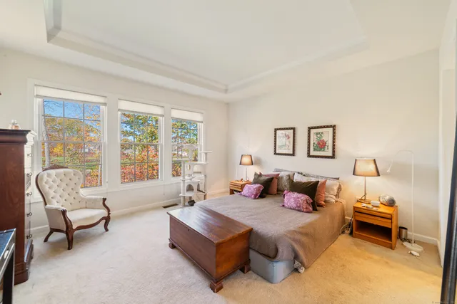 a bedroom with furniture and a large window