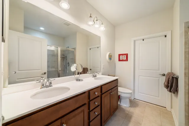 a bathroom with a sink double vanity and a mirror