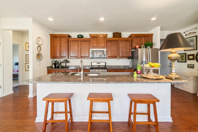 a kitchen with stainless steel appliances granite countertop a sink and cabinets